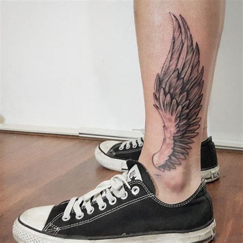 wings on ankle tattoo